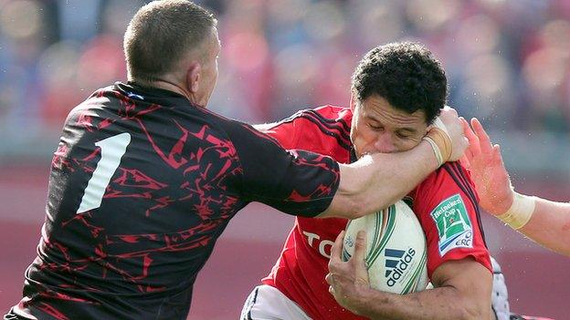 Edinburgh prop John Yapp tackles Munster winger Dougie Howlett at Thomond Park