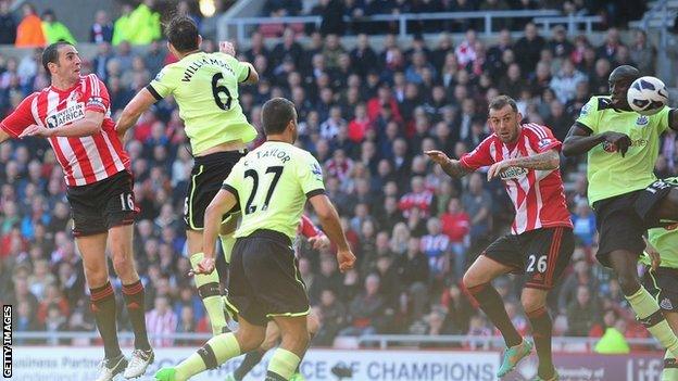 John O'Shea (left) header comes off Demba Ba (right) before going into the Newcastle net