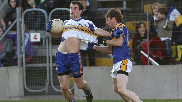 Ronan McRory of Errigal Ciaran is pulled back by Mullahoran opponent Norbert Smith