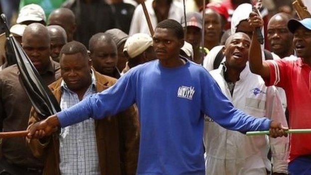 Striking miners chant slogans as they gather at the AngloGold Ashanti mine in Carletonville, north-west of Johannesburg 24 October, 2012