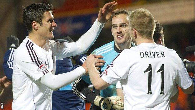 Hearts goalkeeper Jamie MacDonald is congratulated by John Sutton and Andy Driver