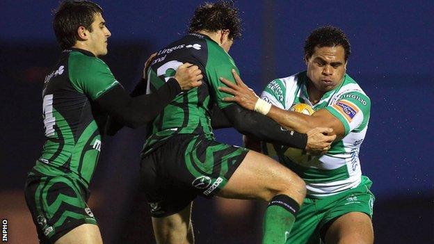 Connacht's Tiernan O'Halloran and Danie Poolman tackle Christian Loamanu of Treviso