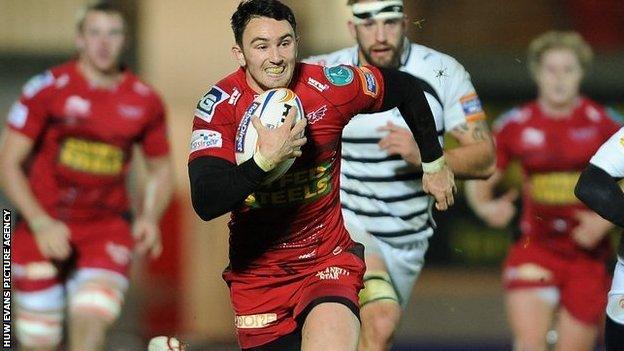 Kristian Phillips races away for the Scarlets