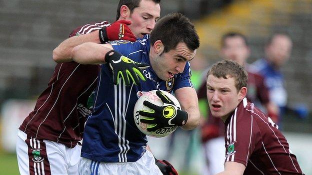 St Gall's forward Kevin Niblock is challenged by Damien Kelly and Aidan Breen