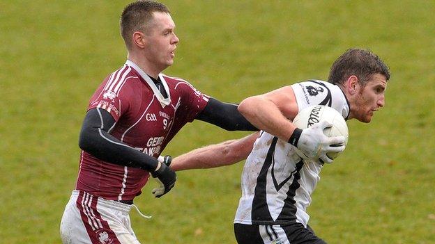 Ballybay's Tommy O'Neill gets a grip on Paul Greenan