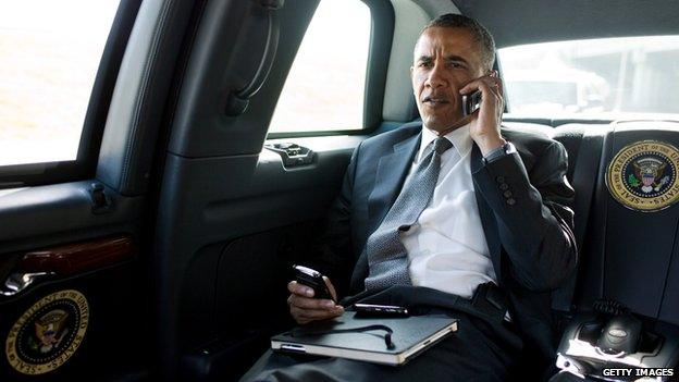 Barack Obama talks on the phone in his motorcade in July 2012