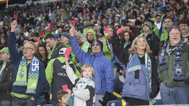 Fans holding up red cards in unity of anti-racism