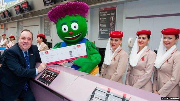 Alex Salmond with Games Mascot Clyde at the Emirates desk at Glasgow Airport