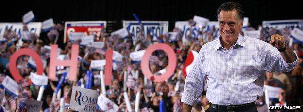 Mitt Romney with a crowd holding up a letters saying 'Ohio'