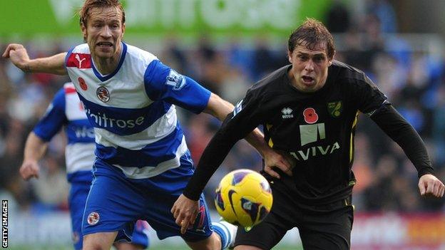 Reading defender Kaspars Gorkss (left) and Norwich striker Grant Holt