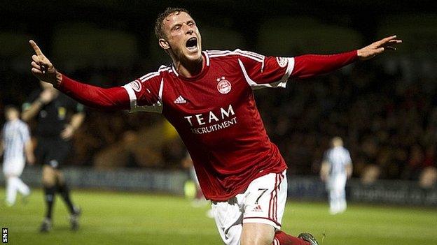 Chris Clark celebrates knocking home Aberdeen's third goal in Paisley