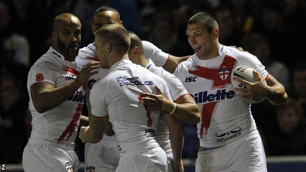 Ryan Hall (right) celebrates with his team-mates after scoring England's first try during the Autumn International Final at the Salford City Stadium against France