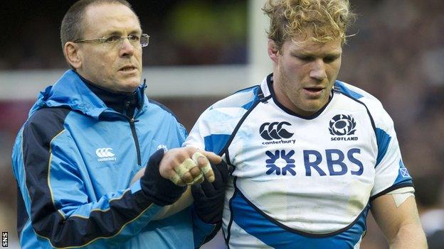 Ross Rennie is led from the field after picking up his injury against New Zealand