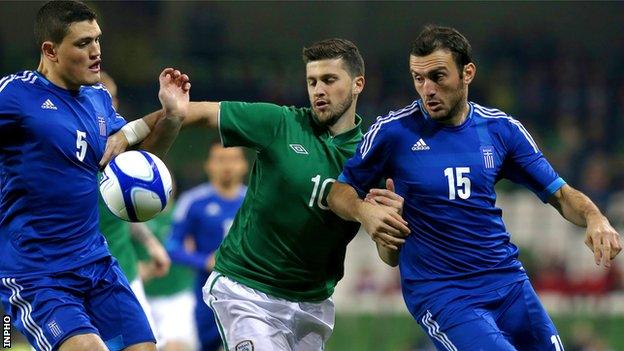 Shane Long battles with Kyriakos Papadopoulos and Vasilis Torosidis in Dublin