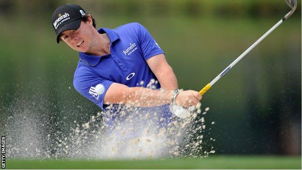 McIlroy plays a bunker shot during the second round