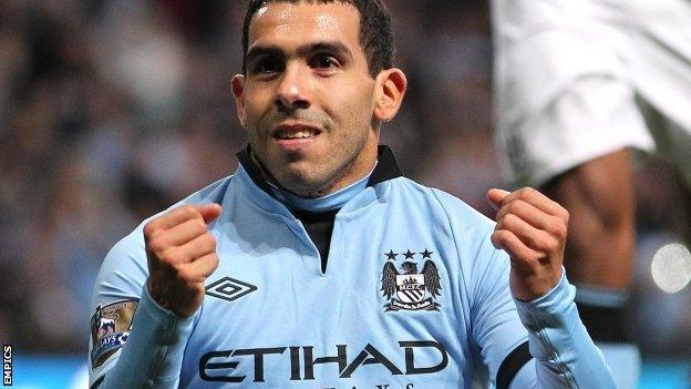 Carlos Tevez celebrates after scoring Manchester City's third goal