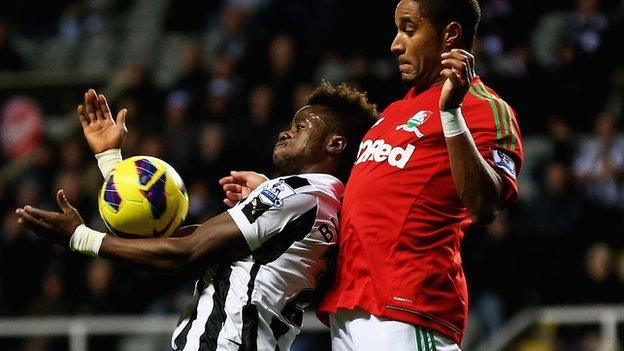 Ashley Williams battles for the ball with Newcastle's Cheick Tiote