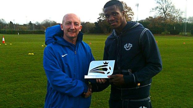 Ian Holloway (left) gives Wilfried Zaha his award