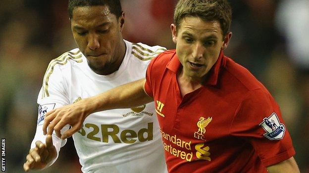 Joe Allen holds off Swansea's Jonathan de Guzman