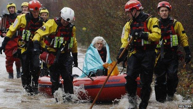 Woman being rescued from flood water