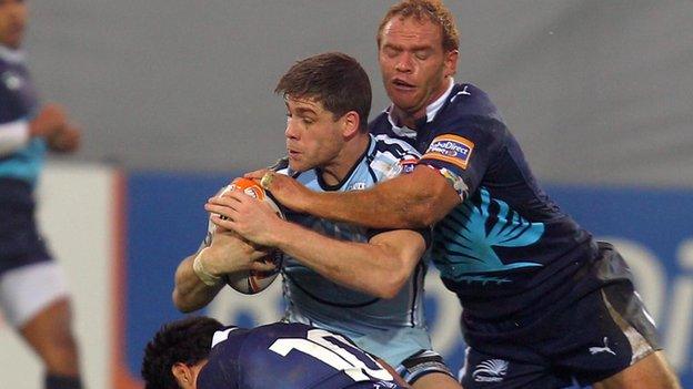 Blues centre Gavin Evans is wrapped up by Zebre fly-half Daniel Halangahu