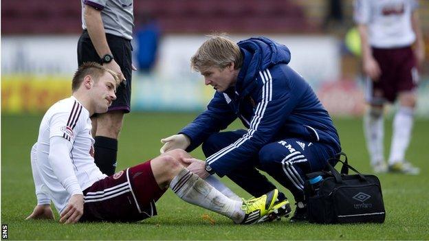 The Hearts physio tends to Danny Grainger