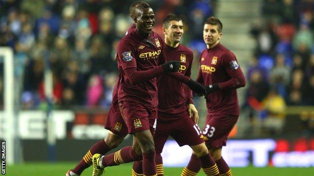 Mario Balotelli celebrates giving Manchester City the lead.