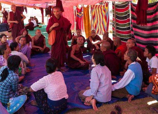 Monks and local farmers taking part in the sit-in at the pagoda inside the copper mine.