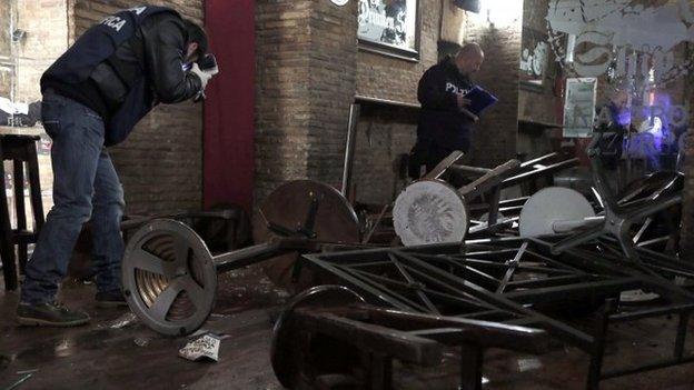 Police CSI officers take photographs in the bar where the fight happened