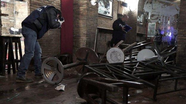 Police CSI officers take photographs in the bar where the fight happened