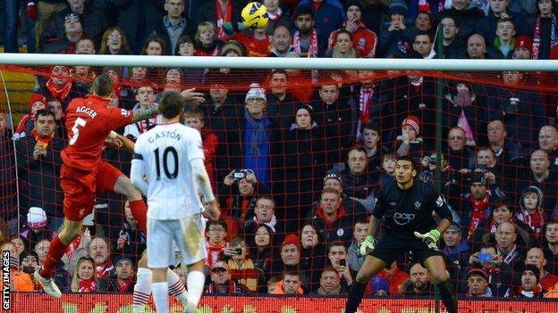 Liverpool defender Daniel Agger (left) heads in a goal against Southampton