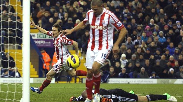 Dean Whitehead celebrates his winner in the background