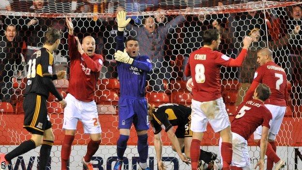 Nottingham Forest's players appeal for handball as Hull City's Paul McShane scores the winning goal