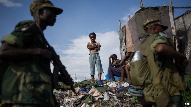 A child watches as Congolese soldiers return to the military barracks in Goma eastern Democratic Republic of the Congo on December 3, 2012.