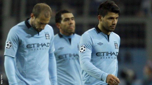 Manchester City's players leave the pitch in dejection after their defeat by Dortmund