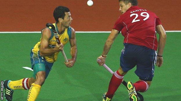 Australia's Jamie Dwyer gets to the ball ahead of England's Richard Smith