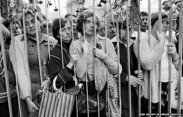 Relatives of the strikers wait outside the headquarters of the Gdansk shipyards