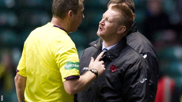 Referee Iain Brines talks with Steve Lomas on the touchline