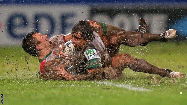 Damien Traille tackles Mike McCarthy at a rain-lashed Parc des Sports Aguilera in Biarritz