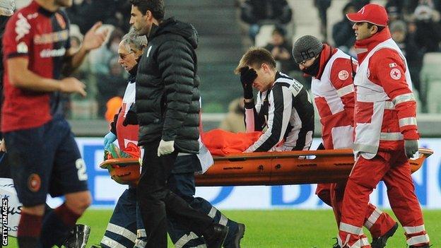 Nicklas Bendtner is carried off on a stretcher