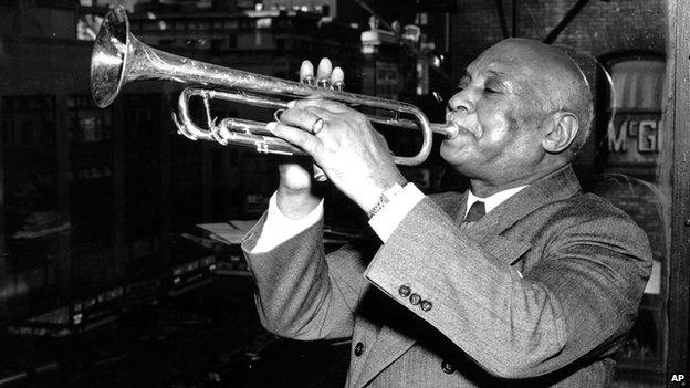 WC Handy playing a trumpet