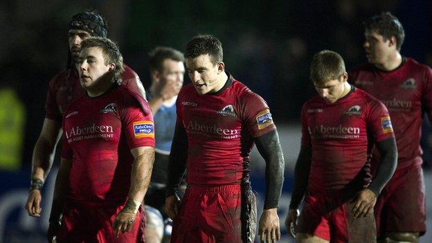 A bedraggled Edinburgh leave the field after losing to Glasgow