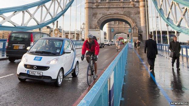 Taxi, car sharing vehicle, bicycle and pedestrians in London