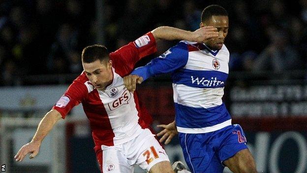 Crawley's Mike Jones is challenged by Reading's Shaun Cummings