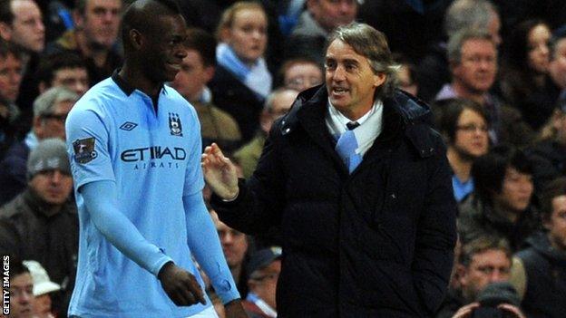 Mario Balotelli (l) with Roberto Mancini