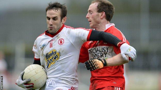 Tyrone's Mark Donnelly battles with Derry's Ciaran Mullan at Healy Park