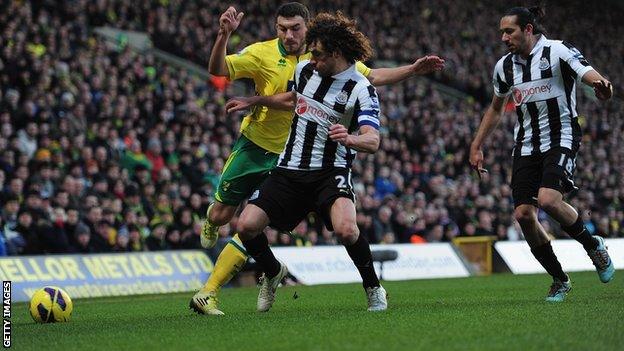 Fabricio Coloccini (middle) tackles Norwich midfielder Robert Snodgrass