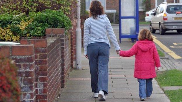 Child walking to school with an adult