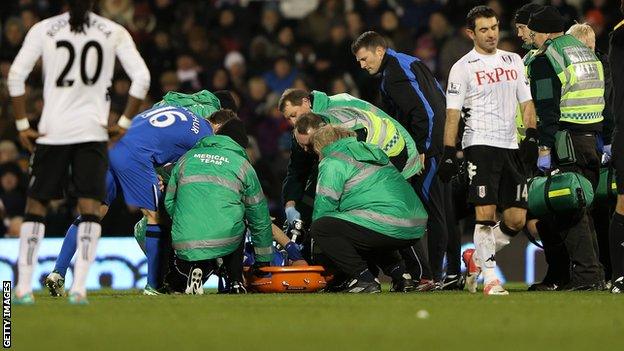 Wigan Athletic defender Ivan Ramis receives treatment for his knee injury at Fulham