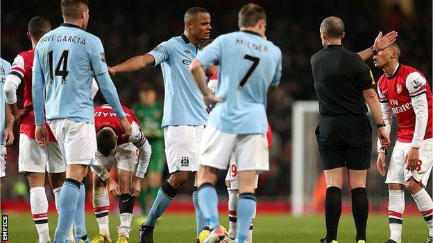 Manchester City captain Vincent Kompany (right) is sent off by referee Mike Dean